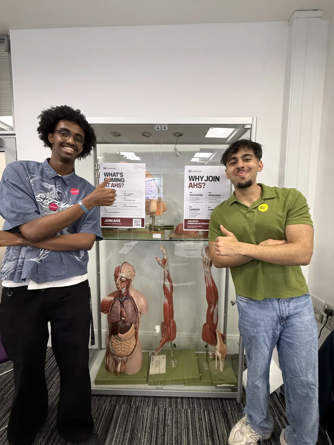 Two Aston Haematology Society committee members beside the Med Fair display